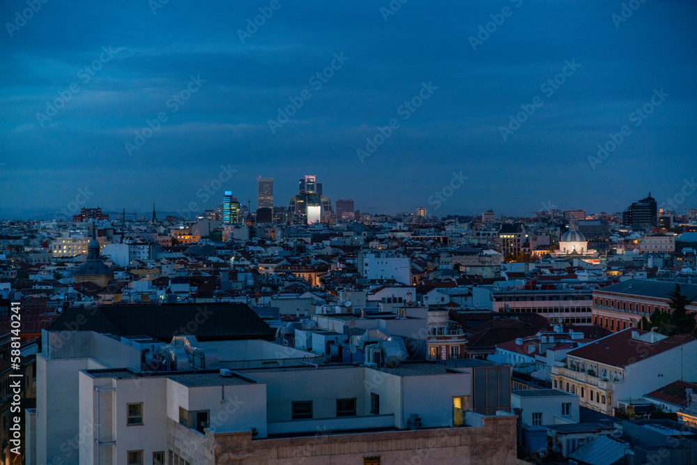 View of the skyline cityscape of Madrid after sunset illuminated, Spain