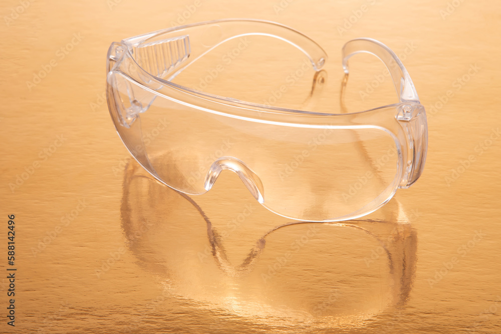 protective work goggles on a golden background protective work goggles on a golden background