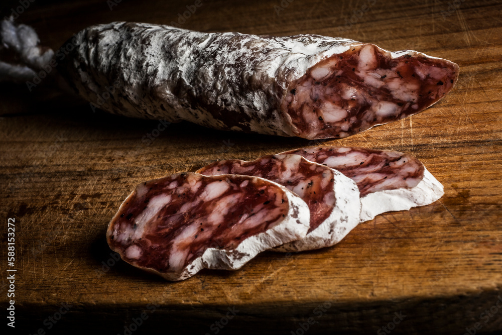 Sausage with mold sliced on wooden table Sausage with mold sliced on wooden table