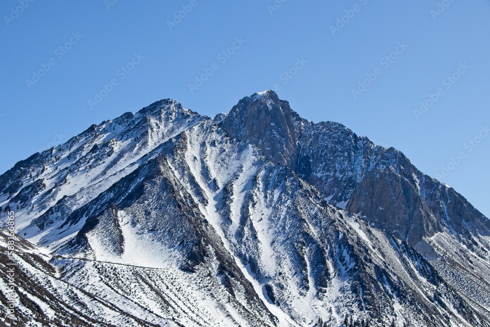 Snow tops the towering peaks of the Sierra Nevada Mountains, seen from the Eastern Sierra