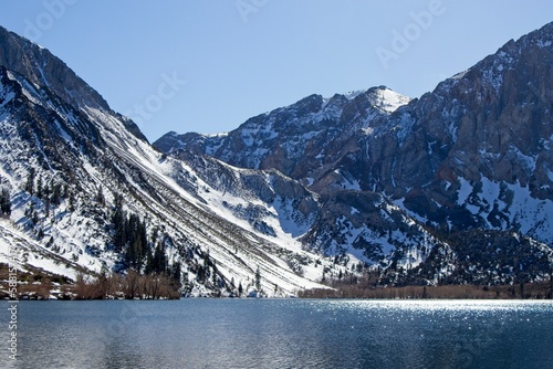 Snowy mountian peaks rise above Convict Lake in the Eastern Sierra, with scenery that is remniscient of the Swiss Alps