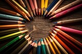 frame with a collection of colored pencils on a wooden table
