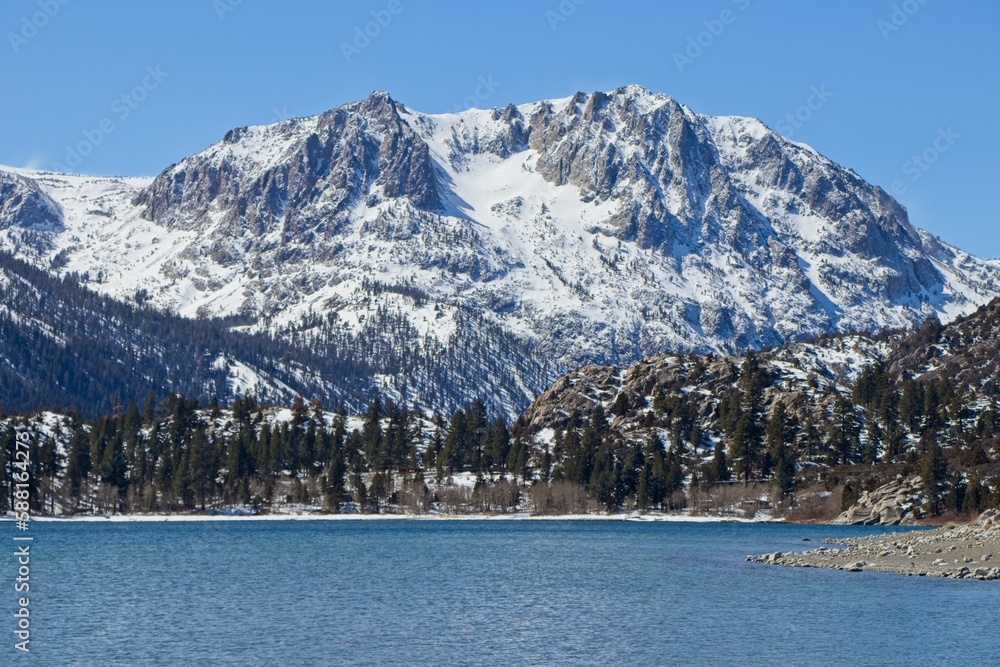 Snow tops the Sierra Nevada Mountains from the crystal clear waters of June Lake, which sits at the bottom of the mountain range's steep eastern escarpment