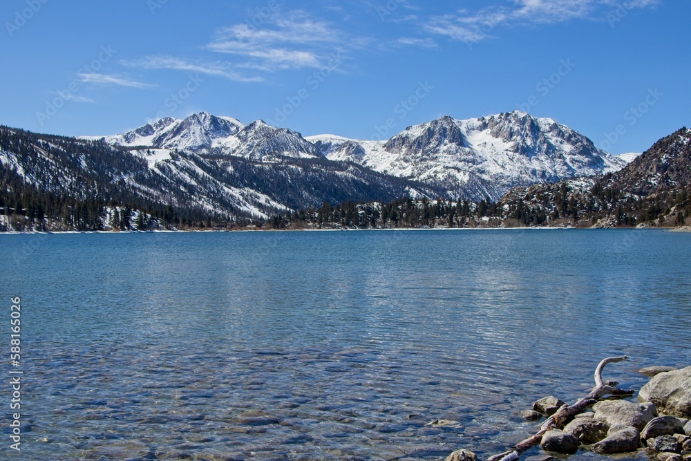 Snow tops the Sierra Nevada Mountains from the crystal clear waters of June Lake, which sits at the bottom of the mountain range's steep eastern escarpment Snow tops the Sierra Nevada Mountains from the crystal clear waters of June Lake, which sits at the bottom of the mountain range's steep eastern escarpment
