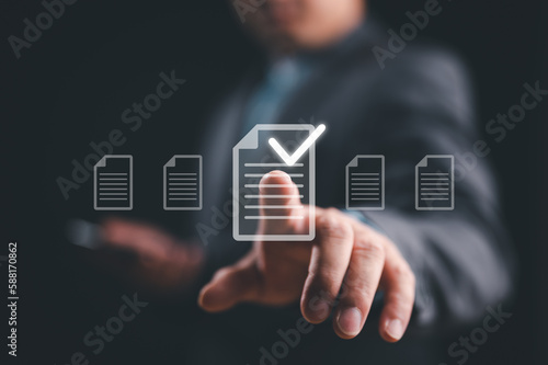 Businessman touching on virtual screen to tick mark document for online approve paperless quality assurance and ERP management, Prepare check and approve concept. Document management, paperless.