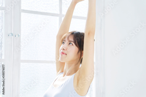 部屋で伸びをする若い女性 Free Download 部屋で伸びをする若い女性 - GFXLoad