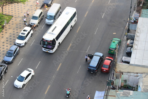 bus and car on a roadway. Picture taken from the rooftop of a tall building. 