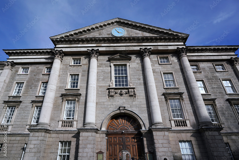Dublin, Ireland - March 2023:  Trinity College, University of Dublin, facade of Regent House with front gate entrance to the old central campus.