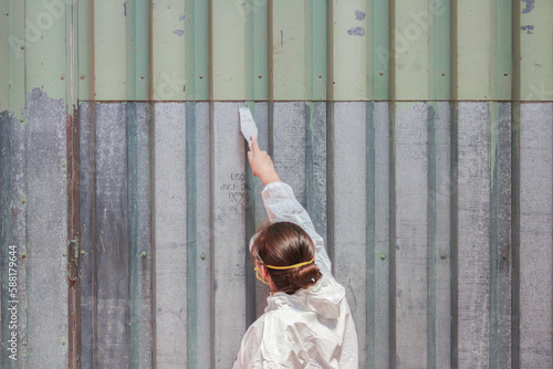 Woman working cleaning a wall