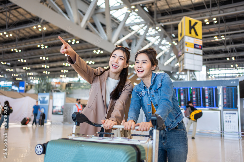 Asian young women passenger walk in airport terminal to boarding gate. Asian young women passenger walk in airport terminal to boarding gate.