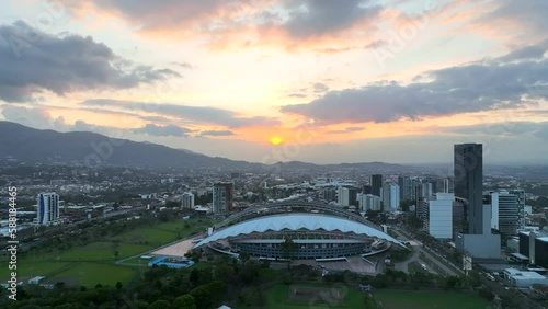 Sunset over downtown San Jose, Costa Rica. Dynamic aerial drone footage of downtown area including the national stadium and La Sabana park.
