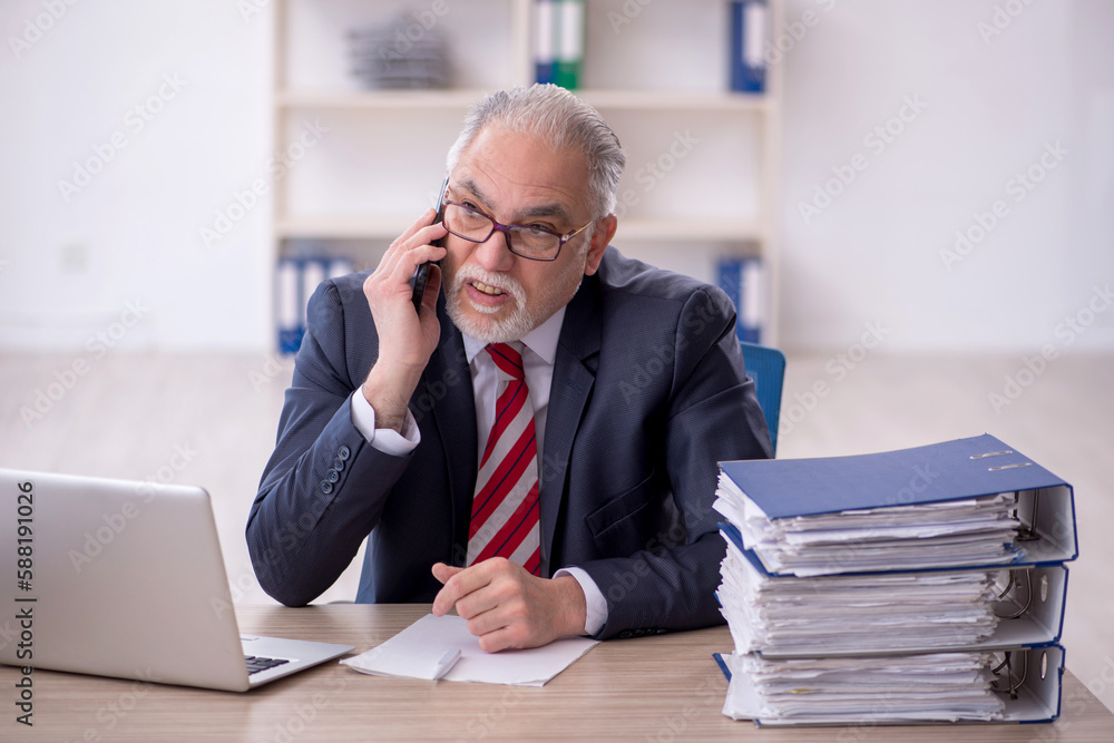 Old male employee and too much work in the office Old male employee and too much work in the office
