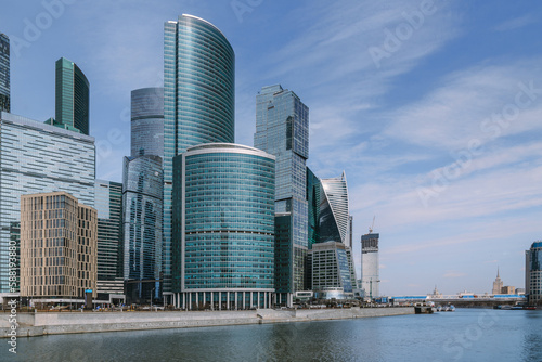View of Skyscrapers of Moscow City district and pedestrian Bridge Bagration across the river in sunny day. Moscow. Russia