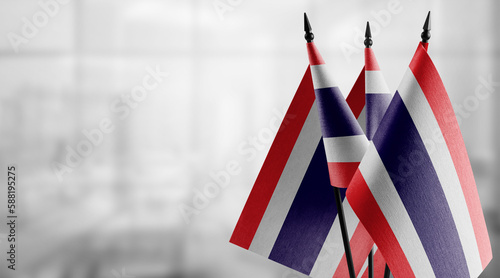 Small flags of the Thailand on an abstract blurry background