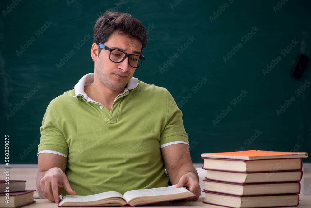 Young male student sitting in the classroom Young male student sitting in the classroom