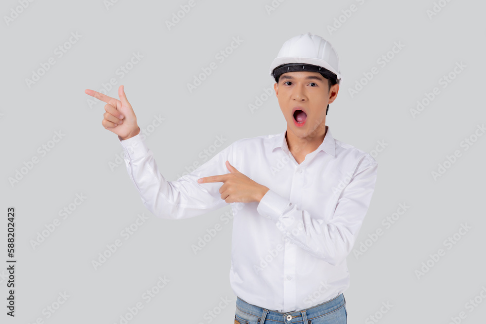 Portrait young asian man is engineer wearing helmet standing and excited isolated white background, male is architect or contractor presenting or showing something with shocked, industrial concept. Portrait young asian man is engineer wearing helmet standing and excited isolated white background, male is architect or contractor presenting or showing something with shocked, industrial concept.