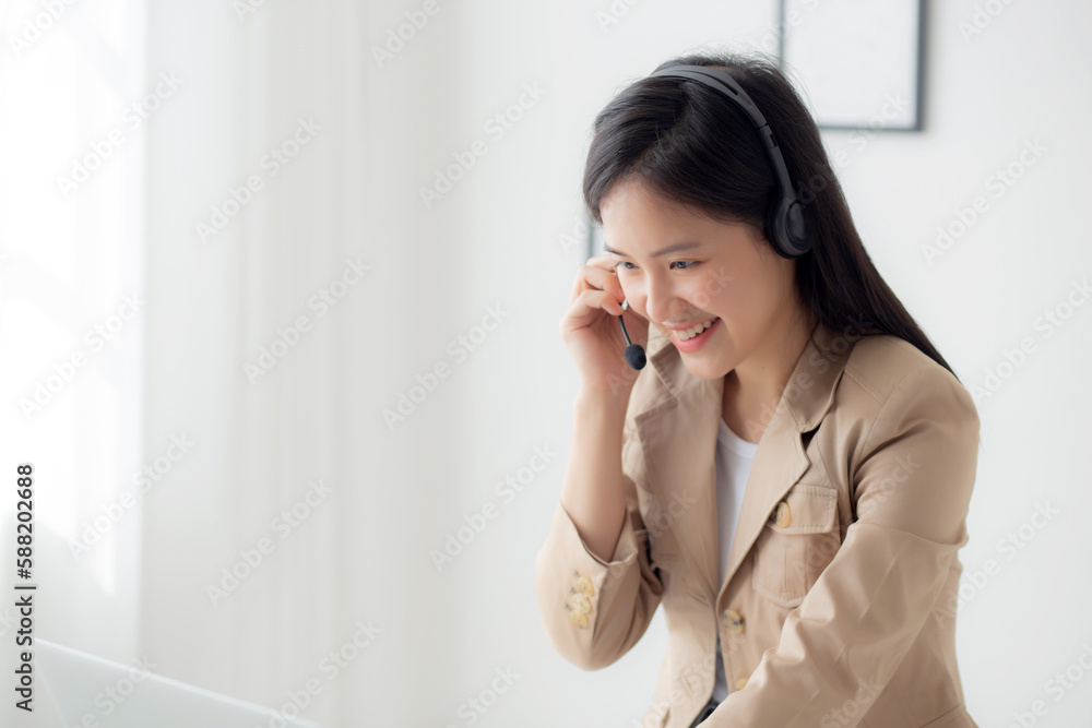 Young asian businesswoman wearing headset video call and explain conference online at home, woman wearing headphone meeting and talking for working from home, business and communication concept. Young asian businesswoman wearing headset video call and explain conference online at home, woman wearing headphone meeting and talking for working from home, business and communication concept.