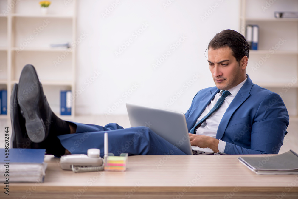 Young male employee working in the office