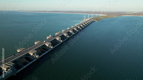 Scenic View Of The Haringvlietdam Bridge And Wind Turbine In Stellendam, Netherlands. Aerial Drone Shot photo