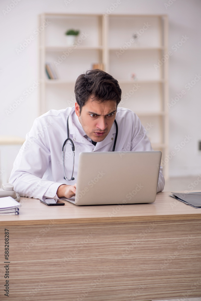 Young male doctor in telemedicine concept Young male doctor in telemedicine concept