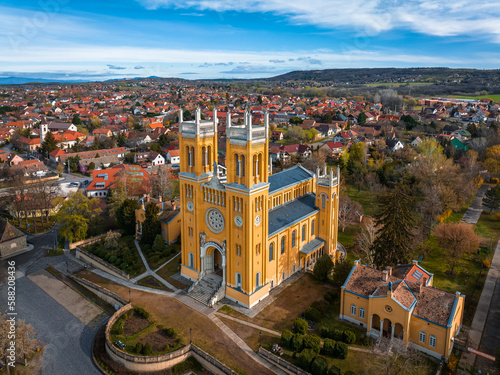 Fot, Hungary - Aerial view of the Roman Catholic Church of the Immaculate Conception (Szeplotlen Fogantatas templom) in the town of Fot on a sunny spring day with blue sky and clouds