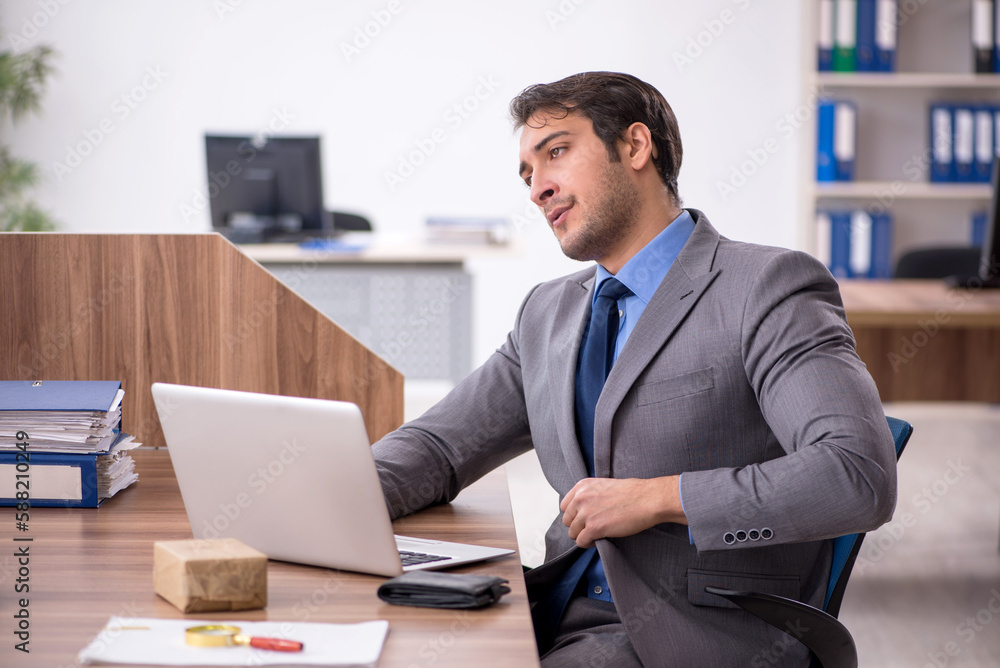 Young male employee working in the office Young male employee working in the office