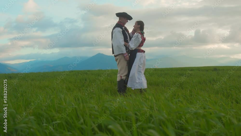 Traditional Slovak couple hugging in field. Traditional Slovak couple hugging in field.