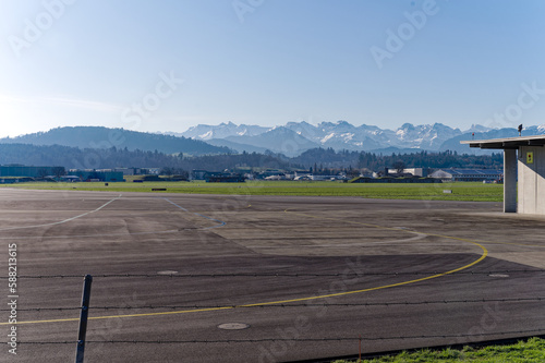 Scenic landscape with Swiss Alps in the background seen from City of Emmen on a sunny spring day. Photo taken March 22nd, 2023, Emmen, Switzerland.