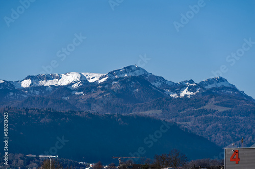 Scenic landscape with Swiss Alps in the background seen from City of Emmen on a sunny spring day. Photo taken March 22nd, 2023, Emmen, Switzerland. © Michael Derrer Fuchs