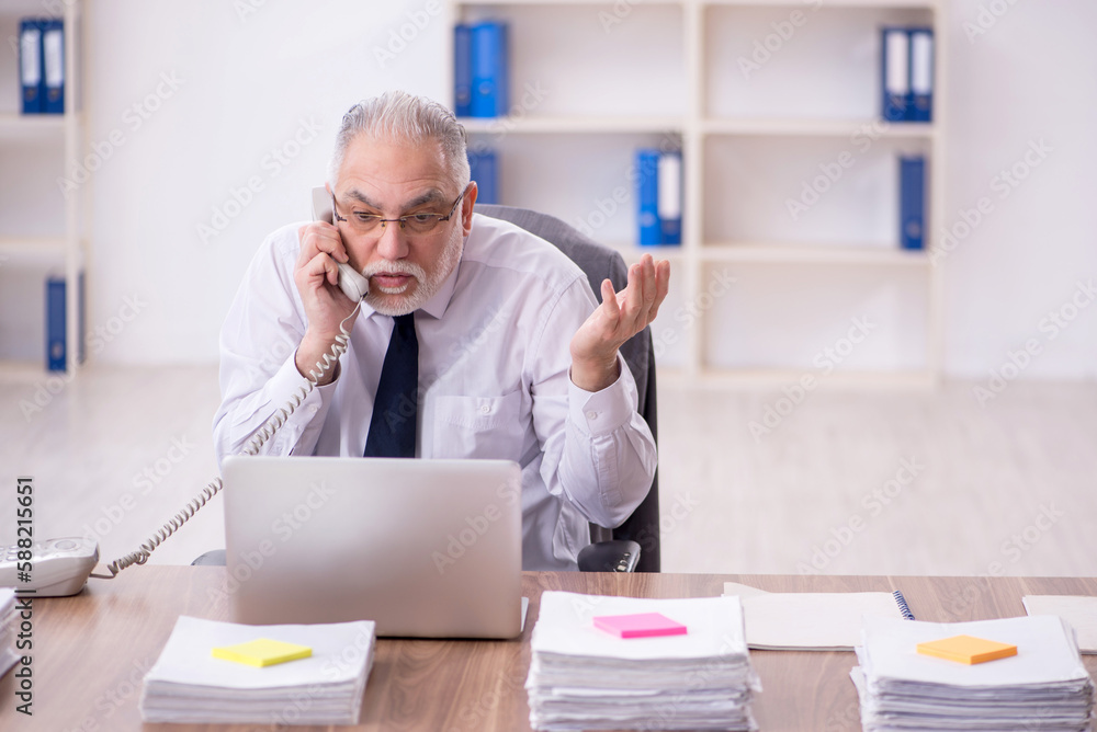 Old male employee and too much work in the office Old male employee and too much work in the office
