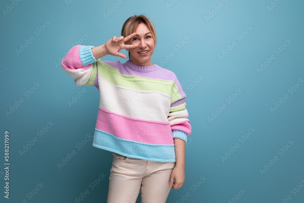 cute blond woman flirting at camera on blue background cute blond woman flirting at camera on blue background