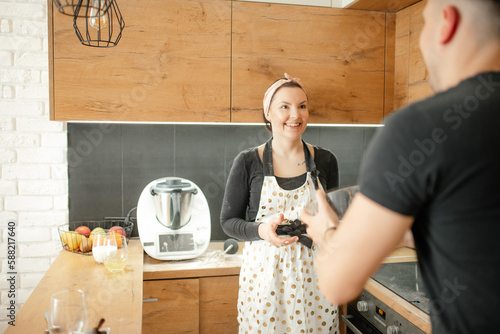 Photography Positive, mischief romantic couple of man and woman in apron fooling around, tal