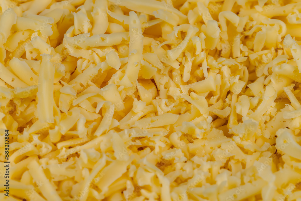 Hard cheese with holes grated into thin small slices Hard cheese with holes grated into thin small slices
