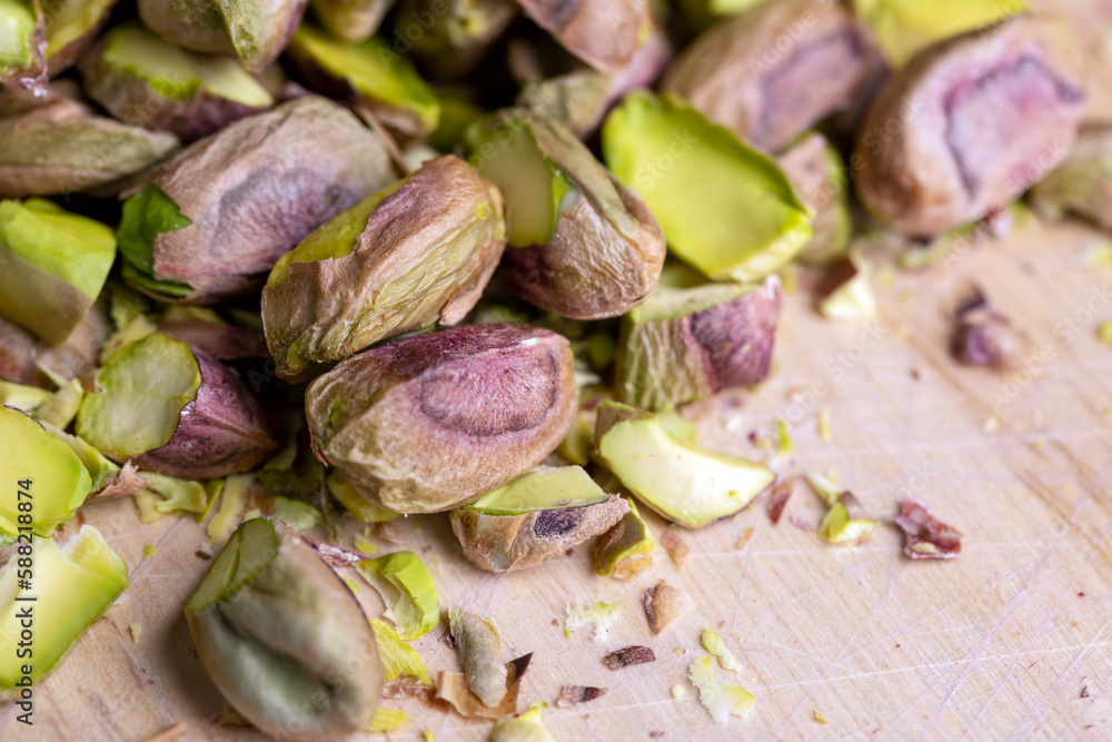 Crispy delicious pistachios with salt on the table Crispy delicious pistachios with salt on the table