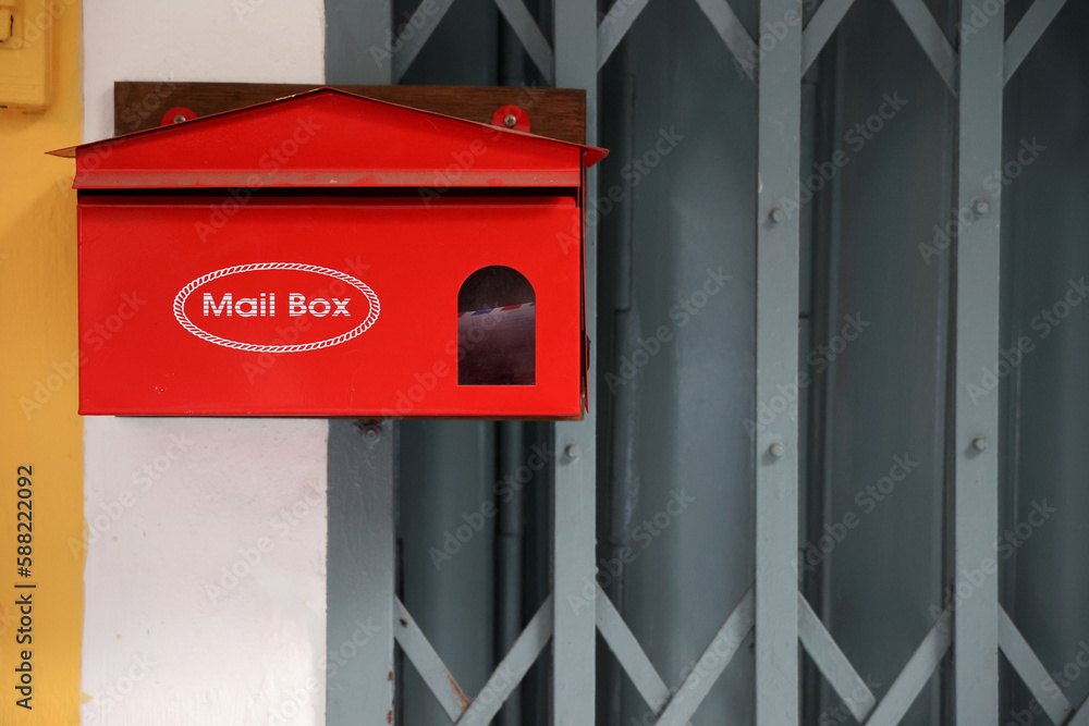 Red mailbox Postbox on silver steel door Red mailbox Postbox on silver steel door