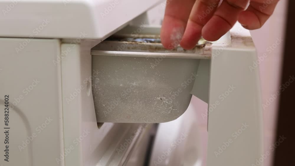 Open washing machine drawer of powder container, side view closeup
