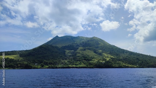 green mountain in the ocean