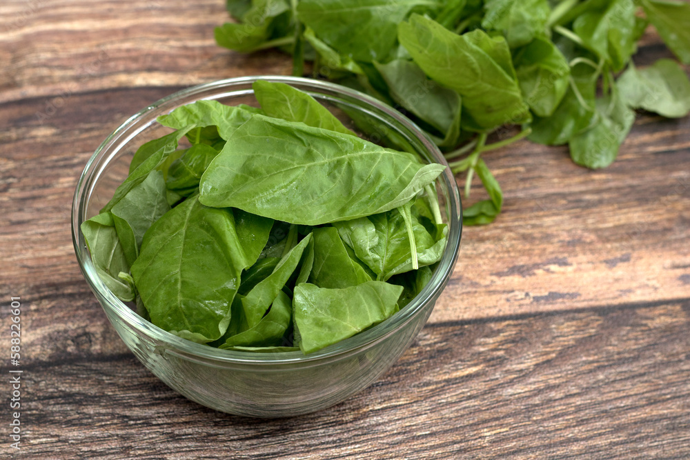 fresh raw spinach leaves in a glass bowl fresh raw spinach leaves in a glass bowl