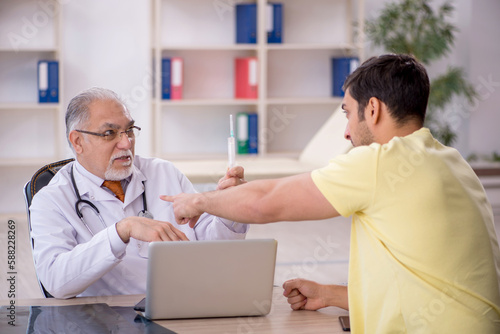 Young male patient visiting old male doctor