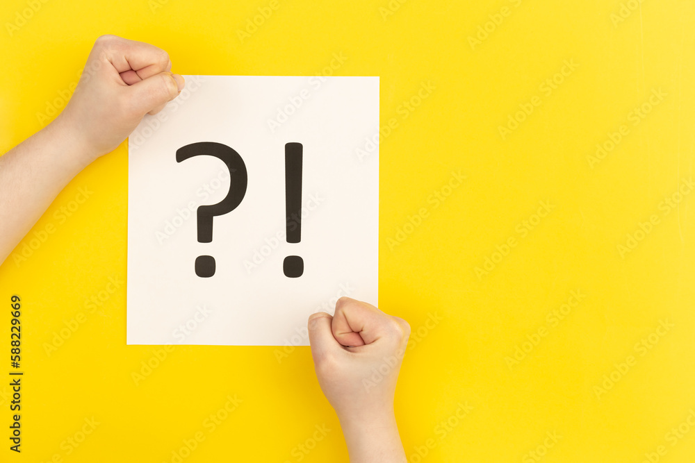 Question mark and exclamation mark on yellow background, flat lay. Question mark and exclamation mark on yellow background, flat lay.