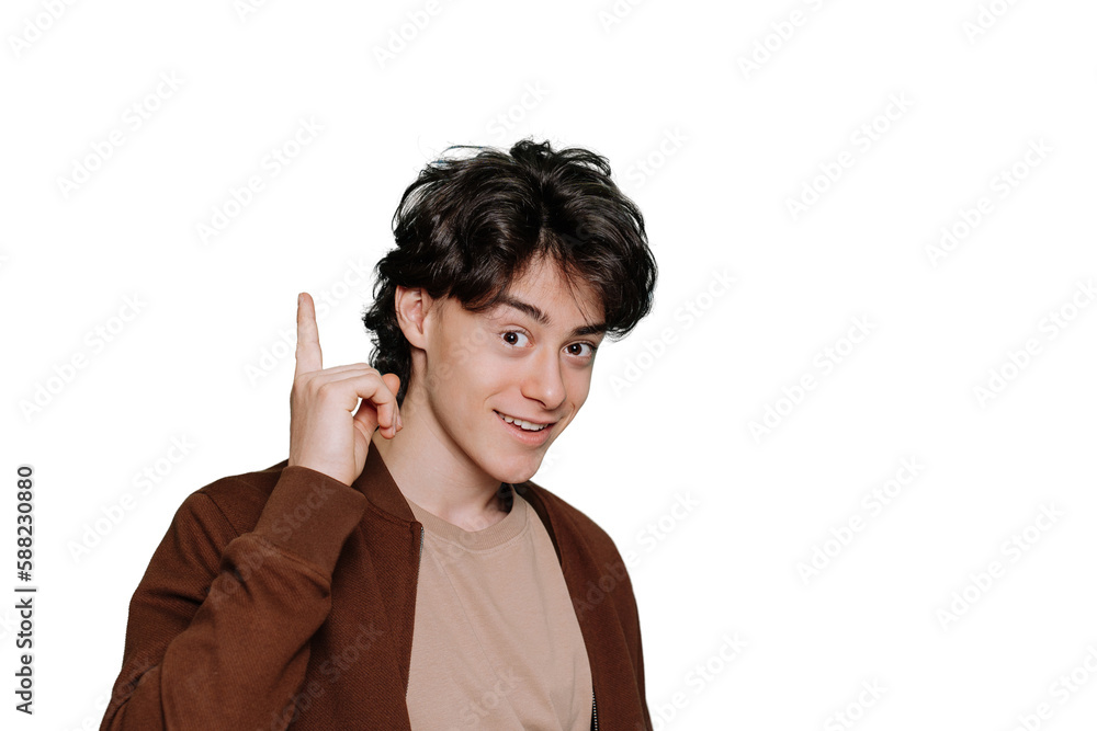 Handsome teenager boy in green brown jacket points by index finger up at workspace area isolated on plain transparent background portrait. Mockup, sale, discount. Idea! Happy guy looks at camera Handsome teenager boy in green brown jacket points by index finger up at workspace area isolated on plain transparent background portrait. Mockup, sale, discount. Idea! Happy guy looks at camera
