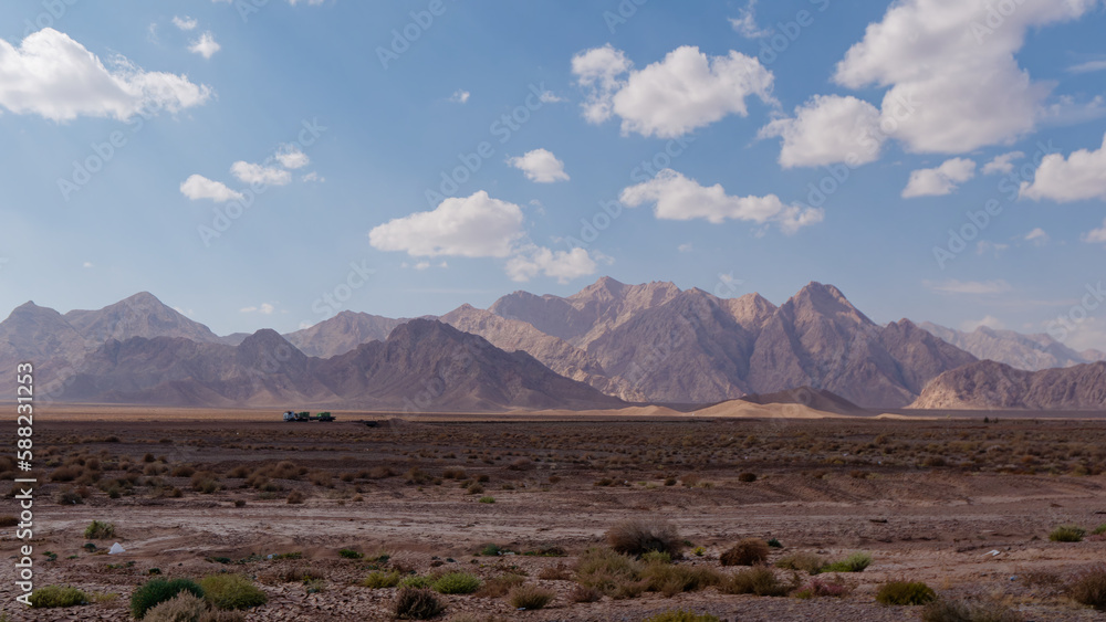 View at the countryside and mountains from the road near Kerman City in Kerman Province, Iran
