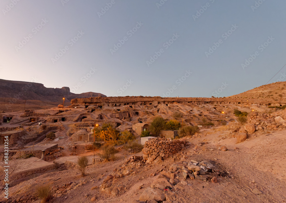 Panoramic view of the ancient rocky village of Meymand at sunset near Shahr-e Babak city in Kerman Province, Iran