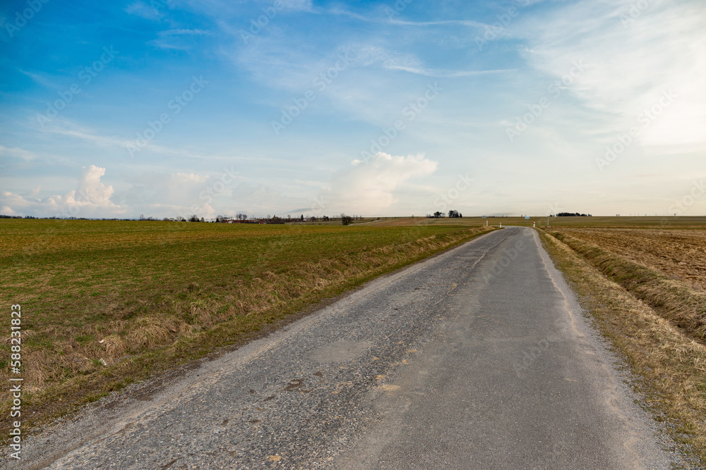 Rural asphalt road in Czechia. Early spring.