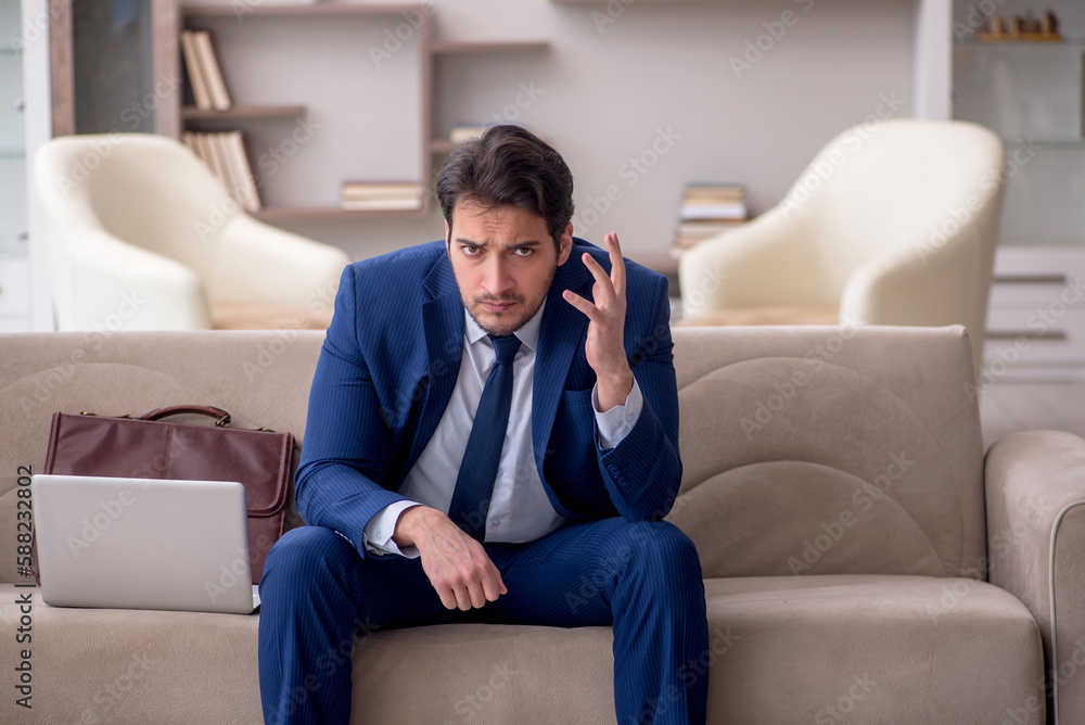 Young male employee working from home during pandemic Young male employee working from home during pandemic