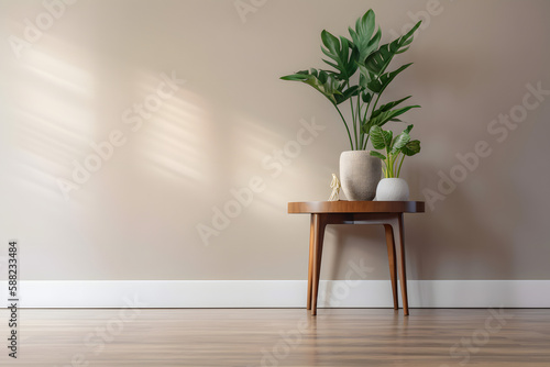 Houseplants in decorative pots on small wooden table in front of beige wall with soft shadows from afternoon sun