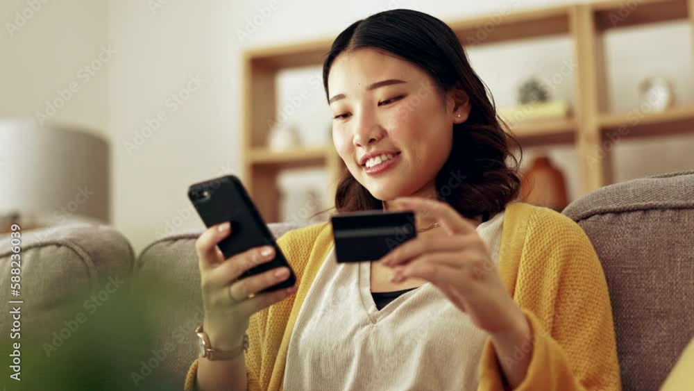 Finance, phone or happy woman online shopping with credit card for discount or sale on digital fintech at home. Financial mobile app, ecommerce payment or Asian girl on sofa banking on internet Finance, phone or happy woman online shopping with credit card for discount or sale on digital fintech at home. Financial mobile app, ecommerce payment or Asian girl on sofa banking on internet