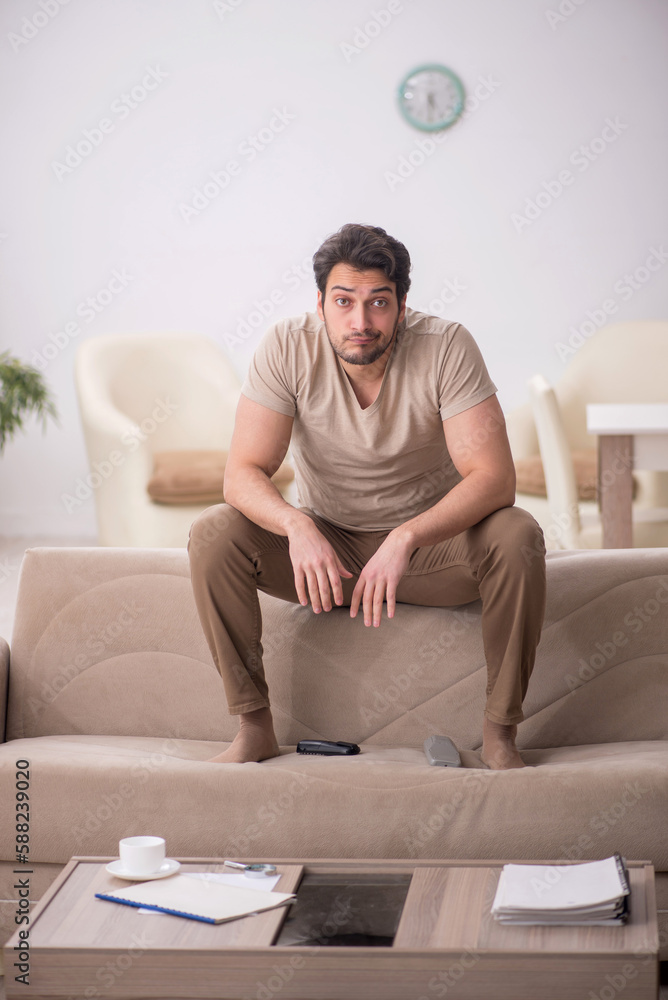 Young man sitting at home during pandemic