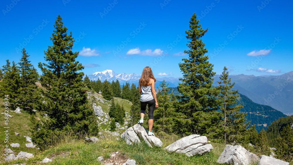 Massif des Bauges in France- Hiker woman enjoying panoramic view of mountain and forest