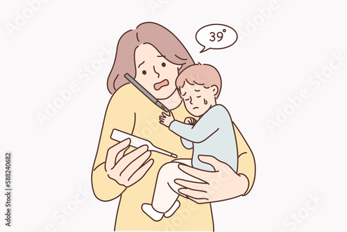 Woman with sick baby holding thermometer and calling pediatrician doctor or calling ambulance